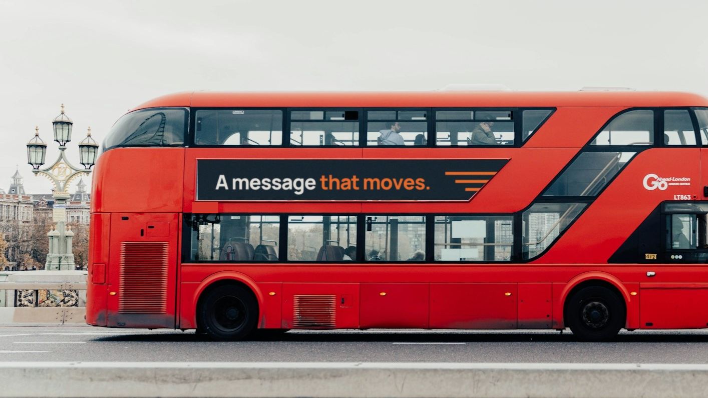 The same bus with a navy side panel reading "A message that moves."